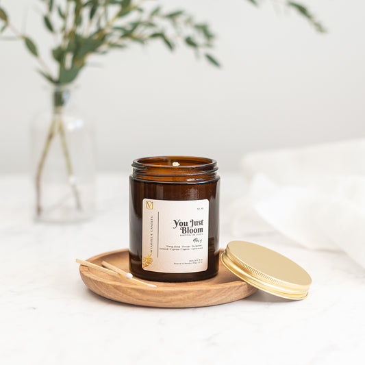 Close up of myariella candles You Just Bloom gingerlily ylang-ylang handmade soy wax candle in amber glass jar