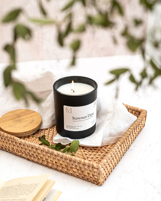 Summer Days candle burning in home interior – handmade Dundee Scotland soy wax summer fragrance in a black candle jar