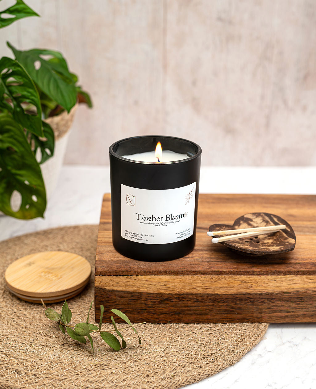 Timber Bloom luxury soy wax candle styled in modern home decor setting, woody jasmine scent.