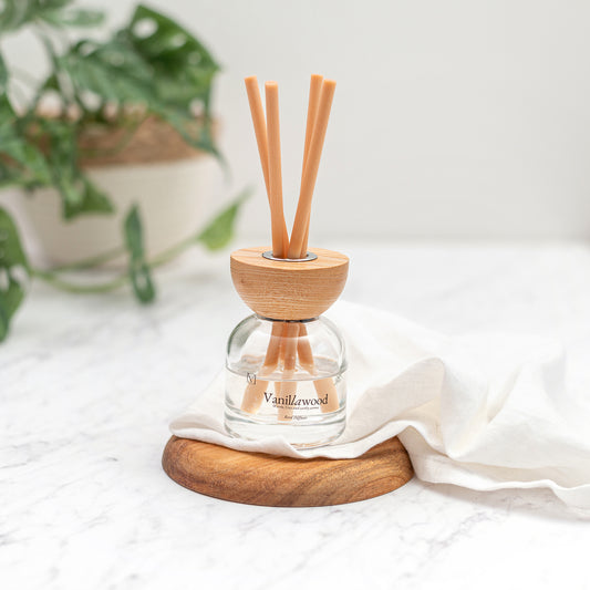 Close up of Vanilla Sandalwood reed diffuser in elegant glass bottle with fibre reeds UK