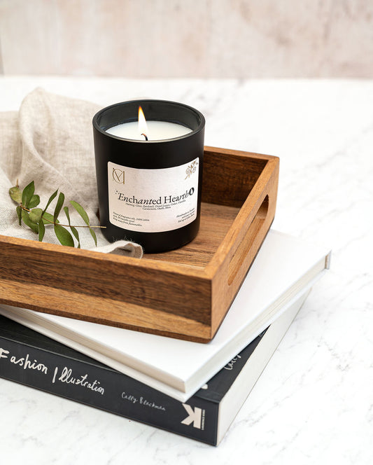Enchanted Hearth candle styled in cosy autumn home decor setting, perfect for winter evenings and relaxation.