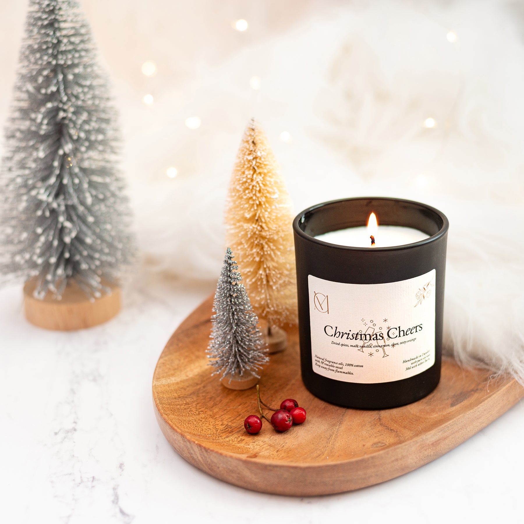 Luxury festive soy candle handmade in Dundee UK styled in cosy Christmas home setting
