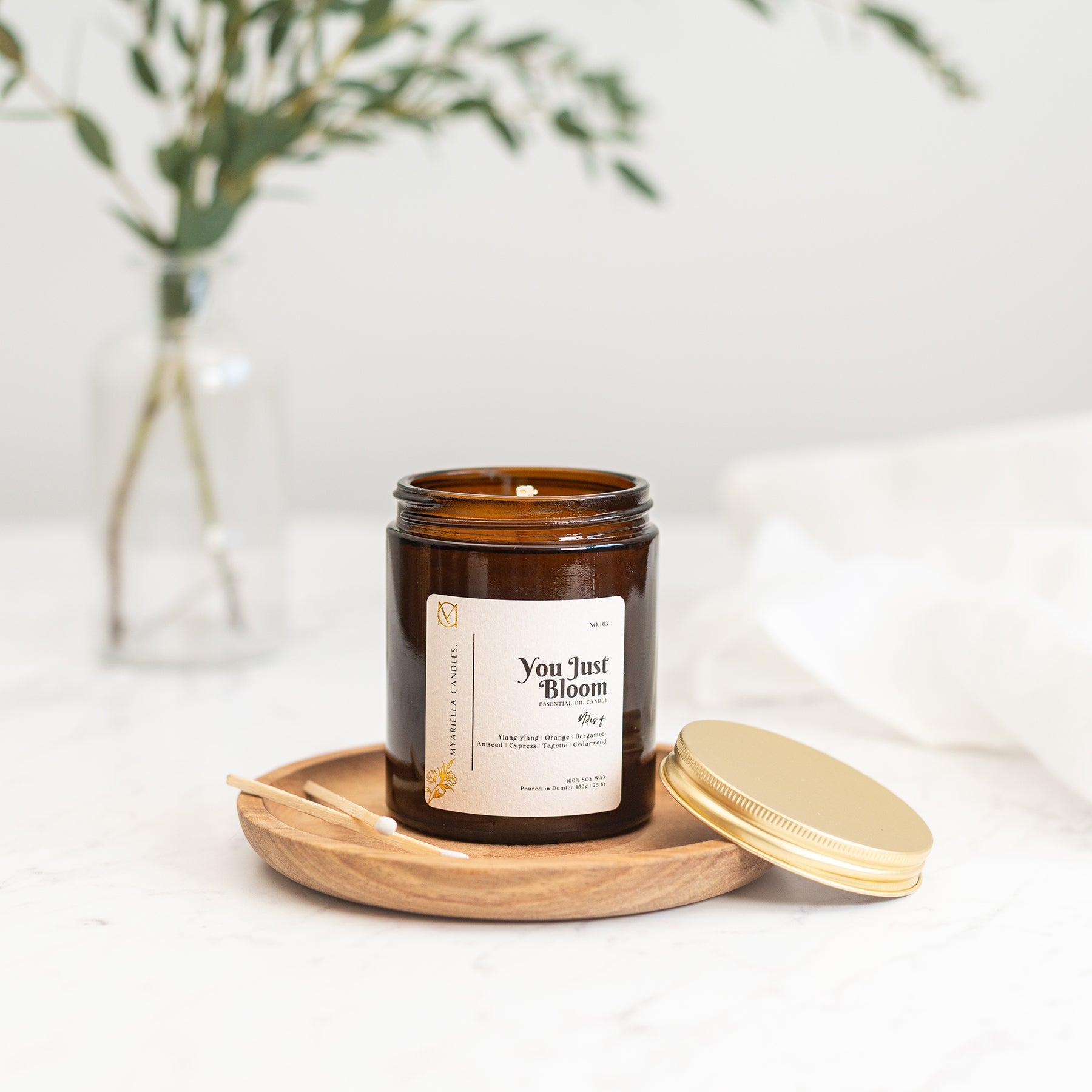 Close up of myariella candles You Just Bloom gingerlily ylang-ylang handmade soy wax candle in amber glass jar