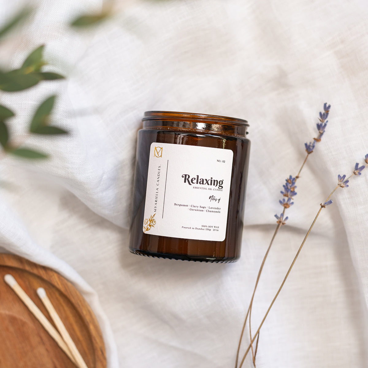 Close-up of handmade natural soy wax lavender candle in amber glass jar by Dundee candle company